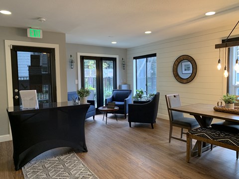 a dining room and living room with a table and chairs